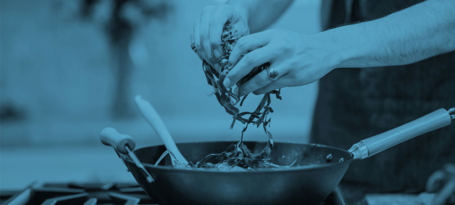 Adding vegetable to a cooking pan